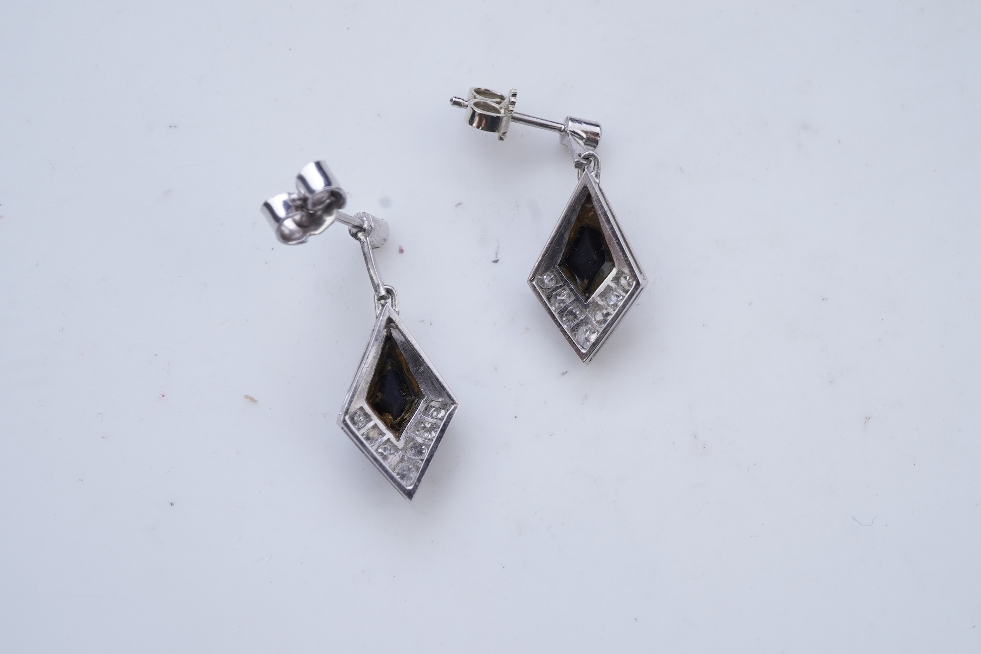 A pair of onyx and diamond earrings